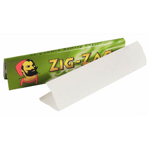 A pack of Zig-Zag brand rolling papers with a green and white color scheme, featuring a cartoon character on the packaging.